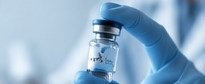 Gloved hand holding a peptide vial